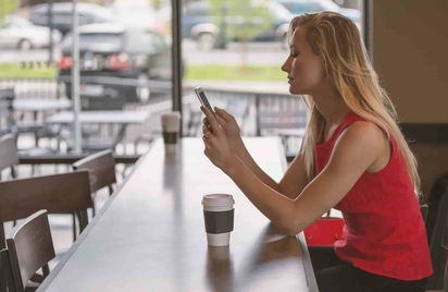 Woman checking her home security system on the Vivint app.