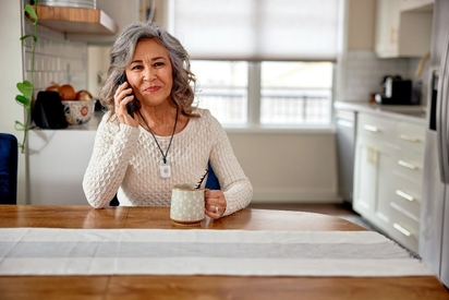 Woman wearing the Vivint Emergency Pendant.
