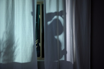 Lurker at a home's window.