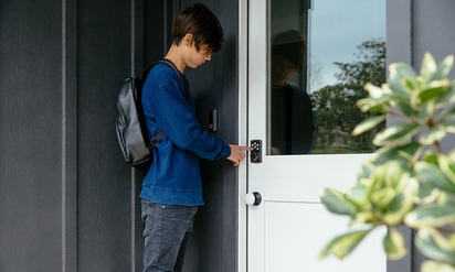 Child using a Kwiset Smart Lock.