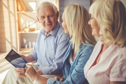 Adult daughter having a conversation with her aging father.
