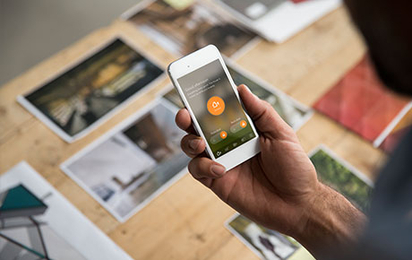 Man arming his security system via the Vivint app.