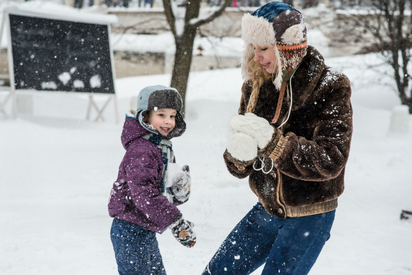 Family playing in the snow.