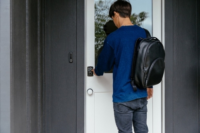 Person entering the code into their Vivint smart lock.