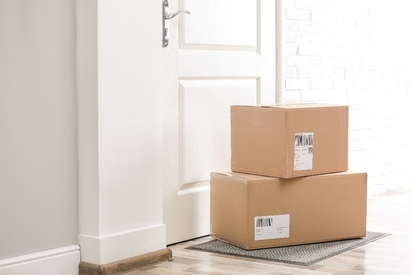 Packages waiting outside an apartment door.