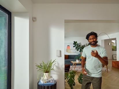 Man checking the Vivint app on his phone.