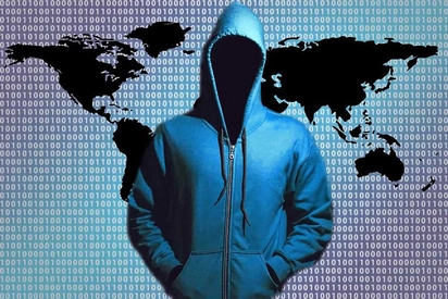 A hacker covering his face with a hoodie.