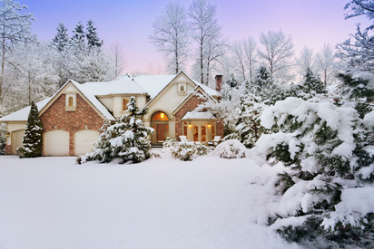 A home's exterior covered in snow.