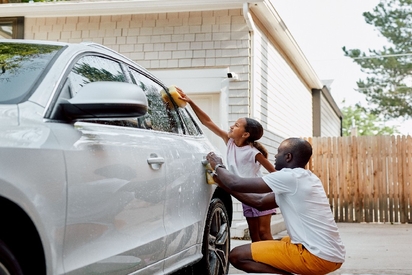 A father and daughter in the front yard of a house protected by a Vivint Outdoor Camera.