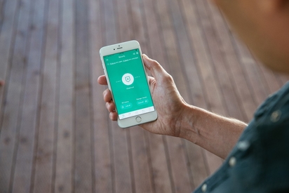 Person arming their Vivint security system via the Vivint app.