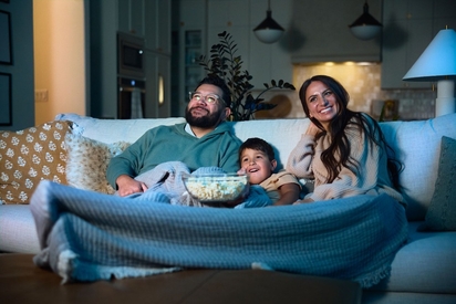 Family watching a movie.