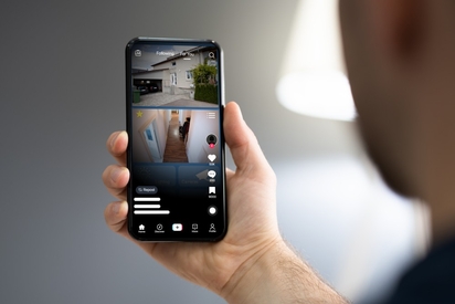 Man watching TikTok on his phone.
