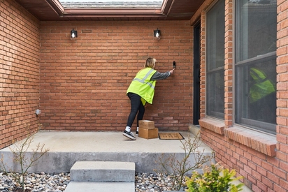 Delivery driver dropping off food on a porch with the Doorbell Camera Pro.