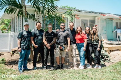 Part of the Vivint team posing in front of the Military Makeover home.