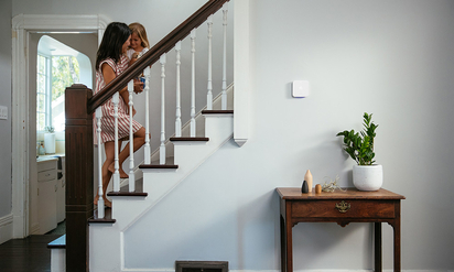 Mother and daughter going up the stairs in a home protected by Vivint.