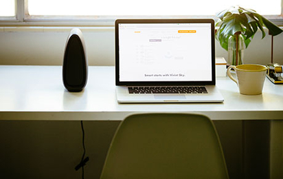 A workspace desk with a laptop set up.