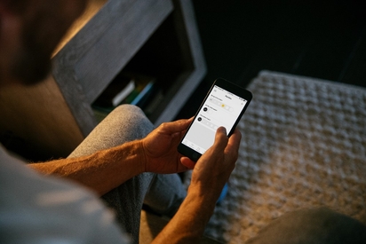 Man using the Vivint app on his phone.