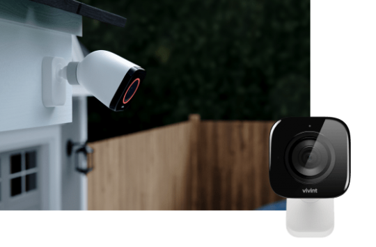 Vivint Outdoor Camera Pro installed outside with view of fence and product image in bottom right corner