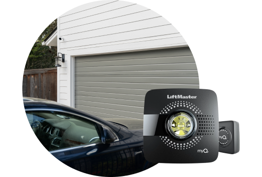 Car pulling up to a garage with garage door control