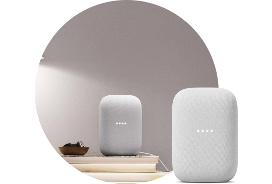 Google Home on a nightstand next to the bed