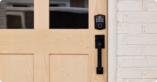 Kwikset Smart Lock mounted on a wooden front door