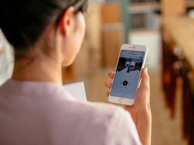 Woman on Outdoor Camera App