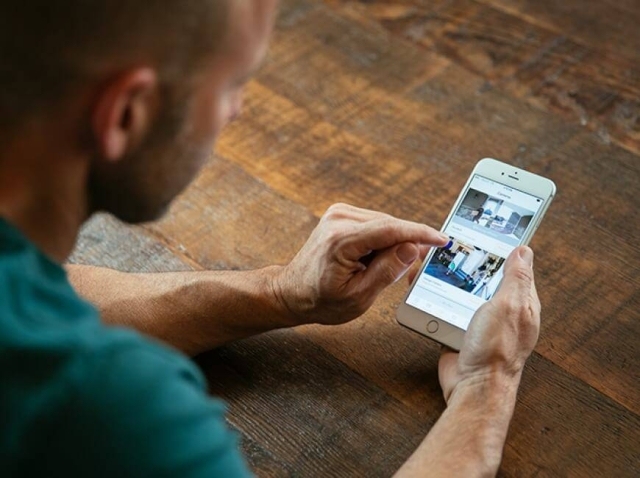 Man at Table Using Vivint App