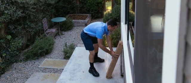 Man Delivering Package at Home