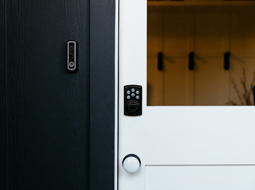 Door with lock and doorbell camera