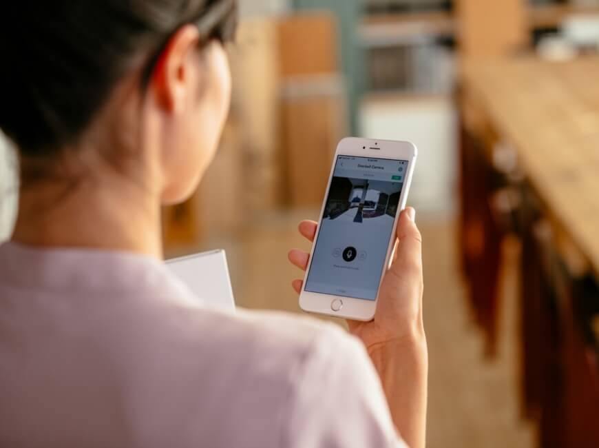 Woman on iPhone at work