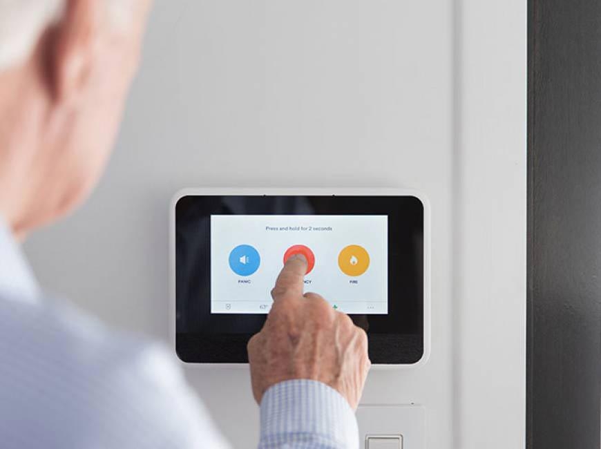 Older Man Pressing 24/7 Monitoring Emergency Button